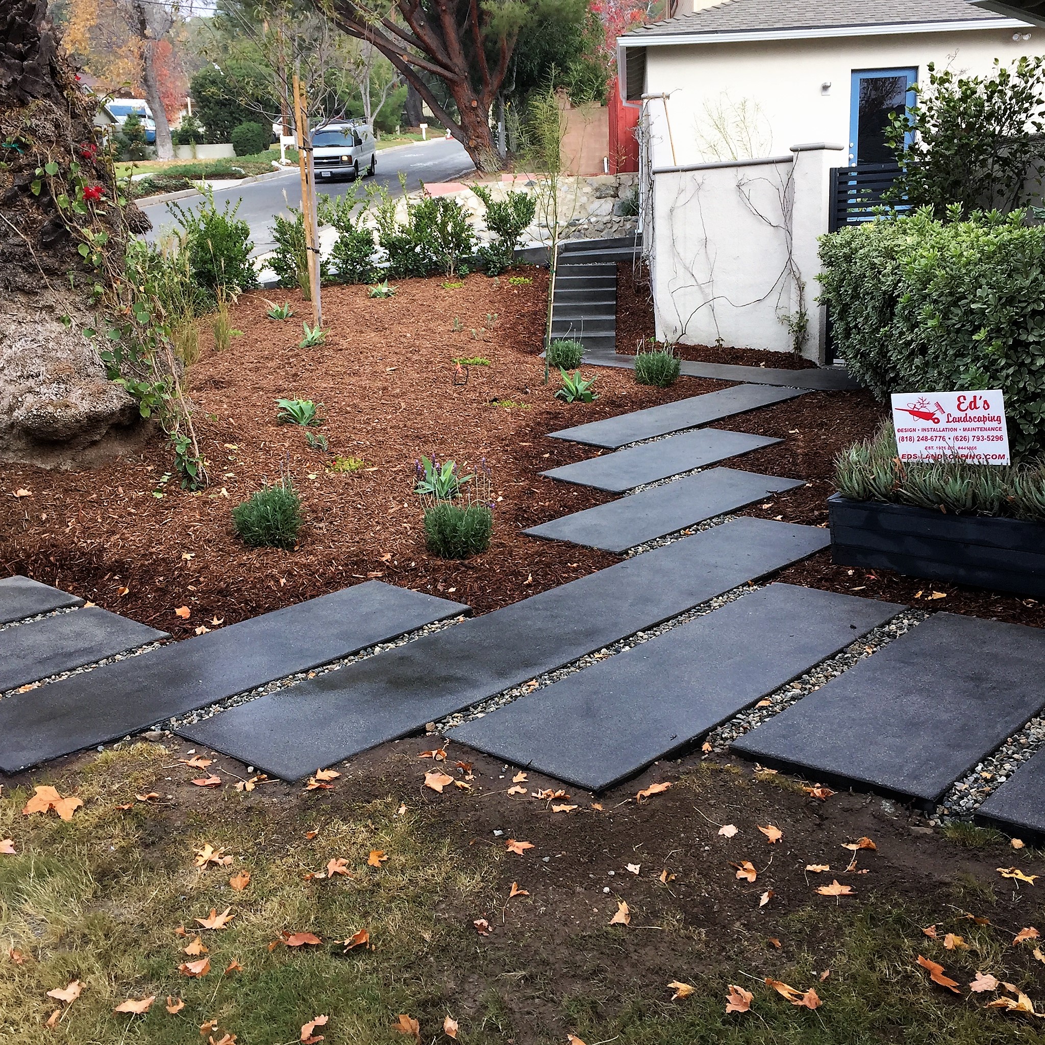 Ed's Landscaping Completed black cement walkway project
